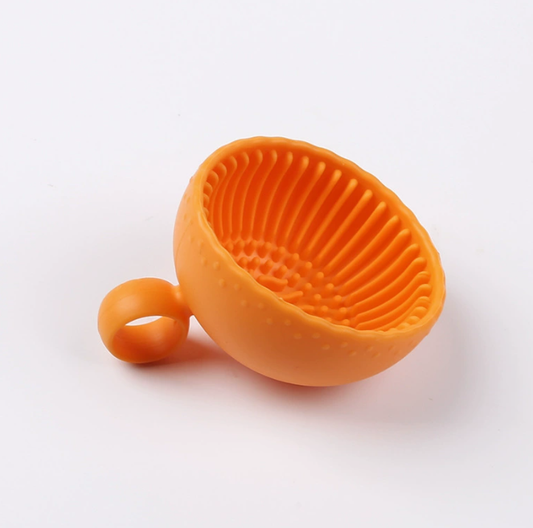 Orange silicone Makeup Brush Cleaning Bowl, Creative Cartoon Brush Cleaner for Brushes & Sponges, Washing Mat & Tool, featuring textured interior for deep cleaning.